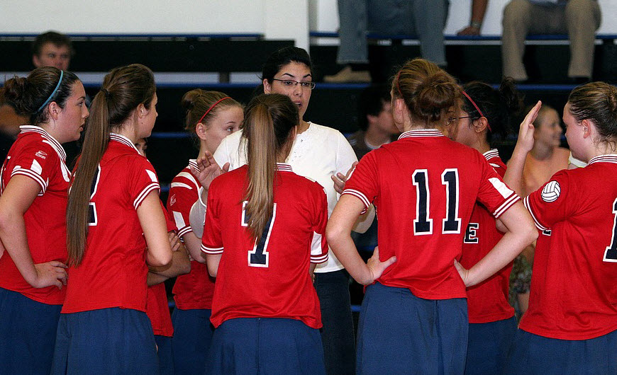 Female trainer coaching her volleyball team